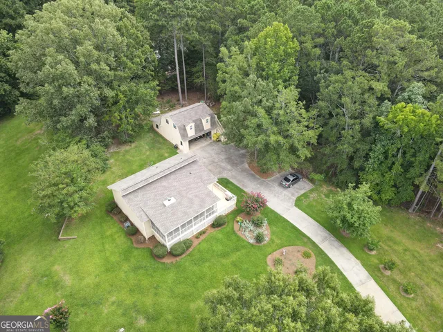 an aerial view of a house with a yard