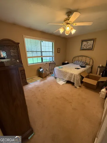 a bed sitting in a bedroom next to a window