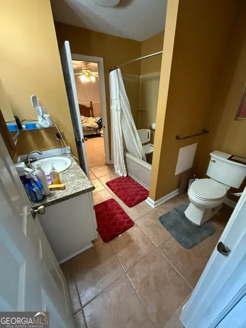 a living room with chairs and a table