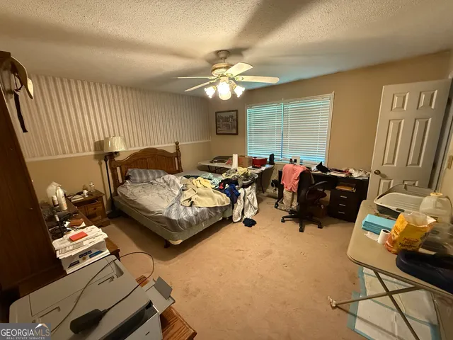 a bedroom with furniture and a window