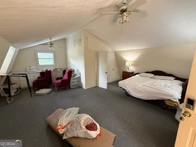 a bedroom with furniture and a window