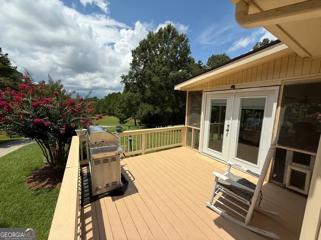 a view of balcony with wooden floor and outdoor seating