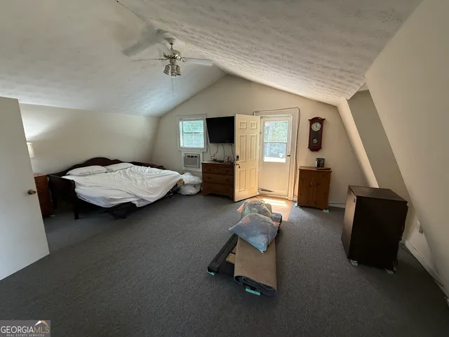 a bedroom with furniture and a flat screen tv