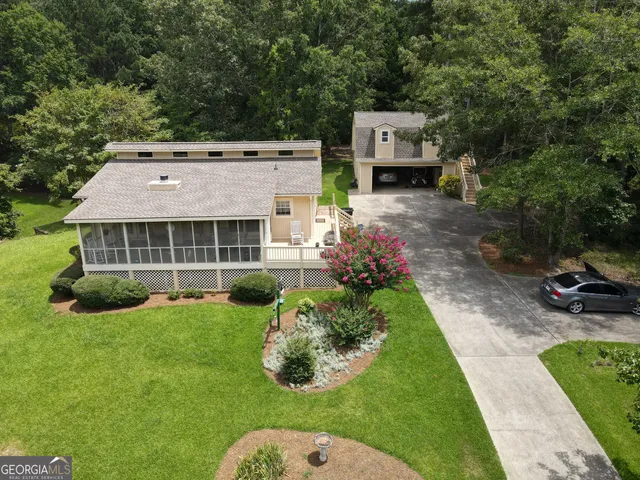 a aerial view of a house with a yard table and chairs