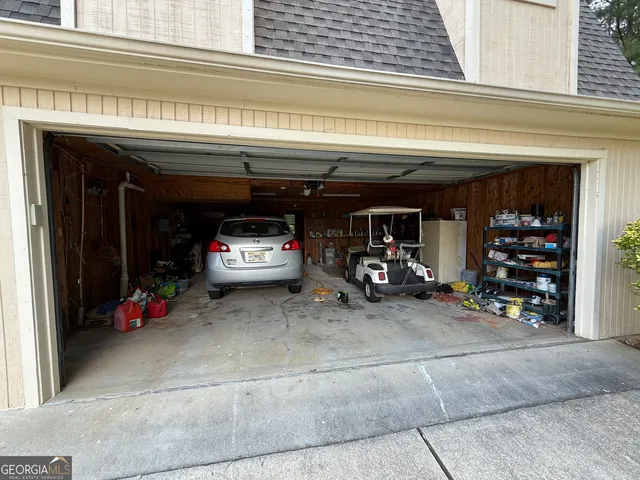 a view of a garage with clothes and shoes
