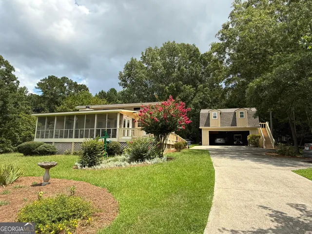 a front view of house with yard and green space