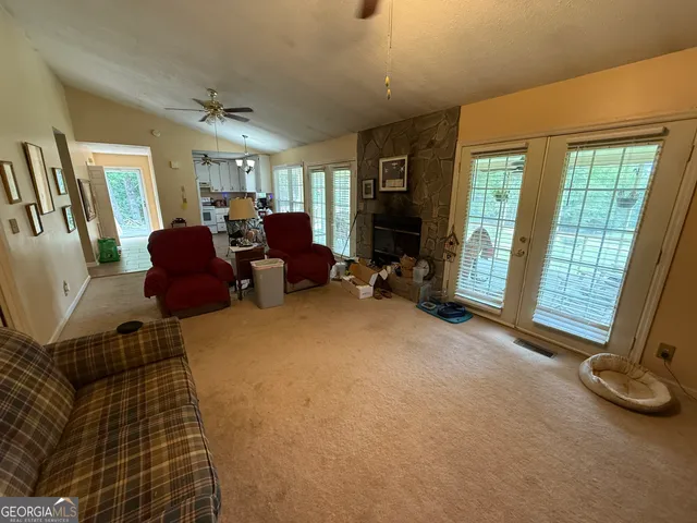 a living room with furniture gym equipment and a fireplace