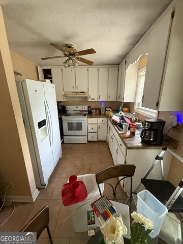 a kitchen with a refrigerator and a stove