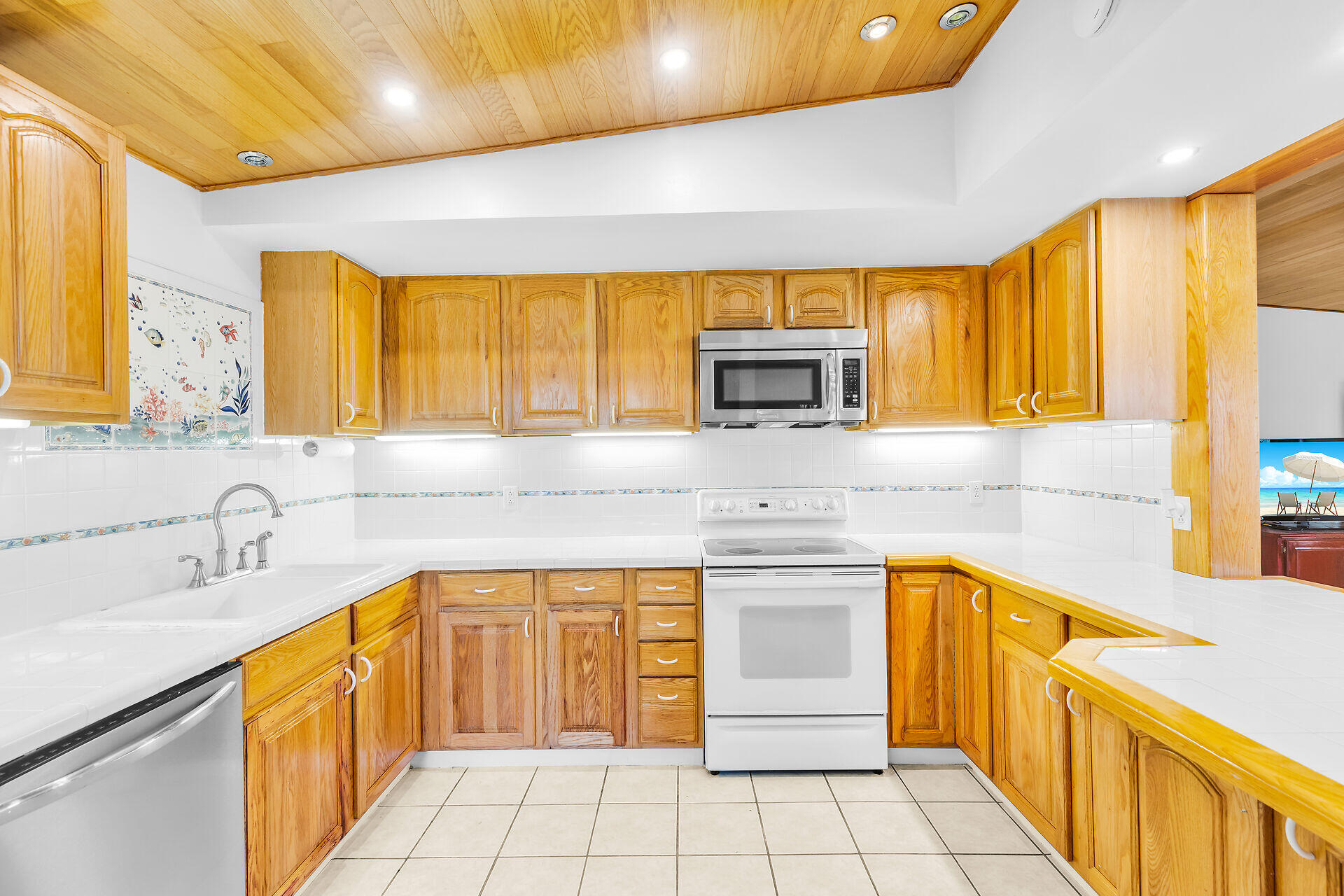 13 Bass Avenue Key Largo, FL 33037 - Photo 13 of 43 a kitchen with stainless steel appliances a sink a stove cabinets counter space and a window