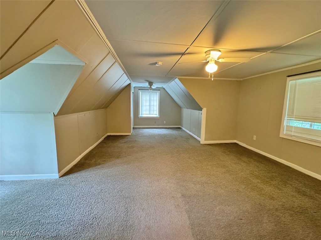 254 Howland Wilson Road Southeast Warren, OH 44484 - Photo 8 of 9 Bonus room featuring ceiling fan, vaulted ceiling, and light colored carpet