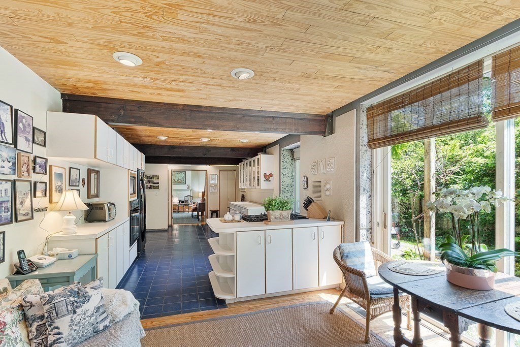 49 Thissell Street Beverly, MA 01915 - Photo 12 of 36 a living room with furniture a wooden floor and a large window