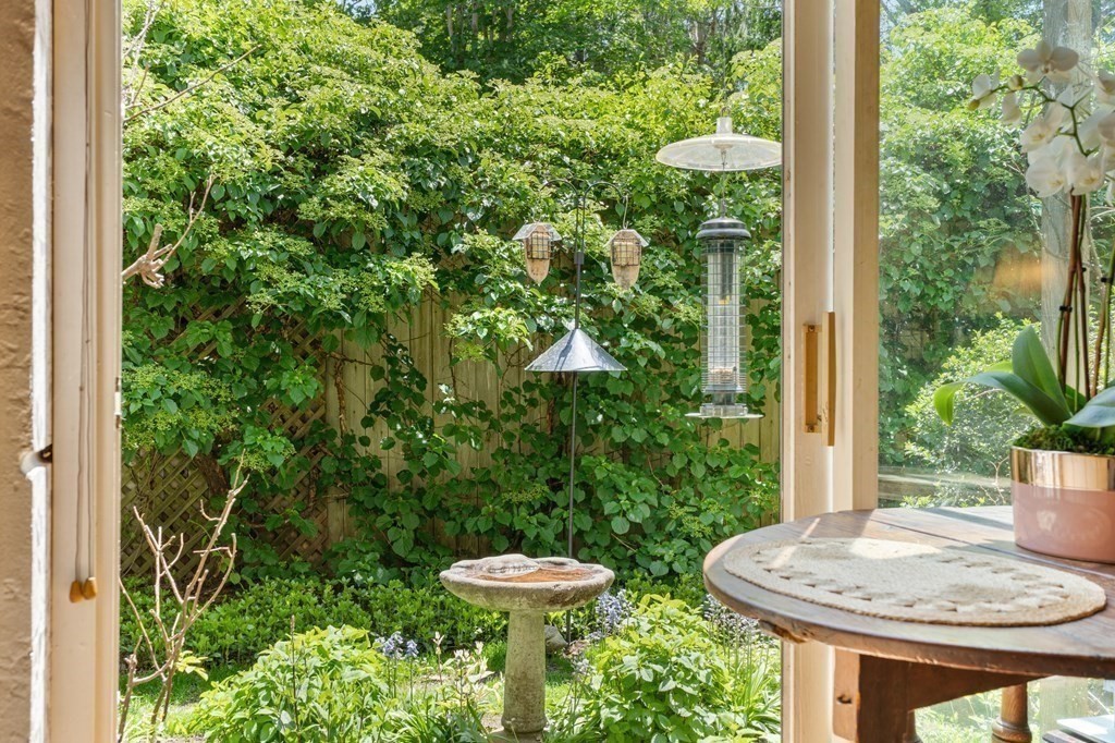 49 Thissell Street Beverly, MA 01915 - Photo 14 of 36 a view of a porch with furniture and plants