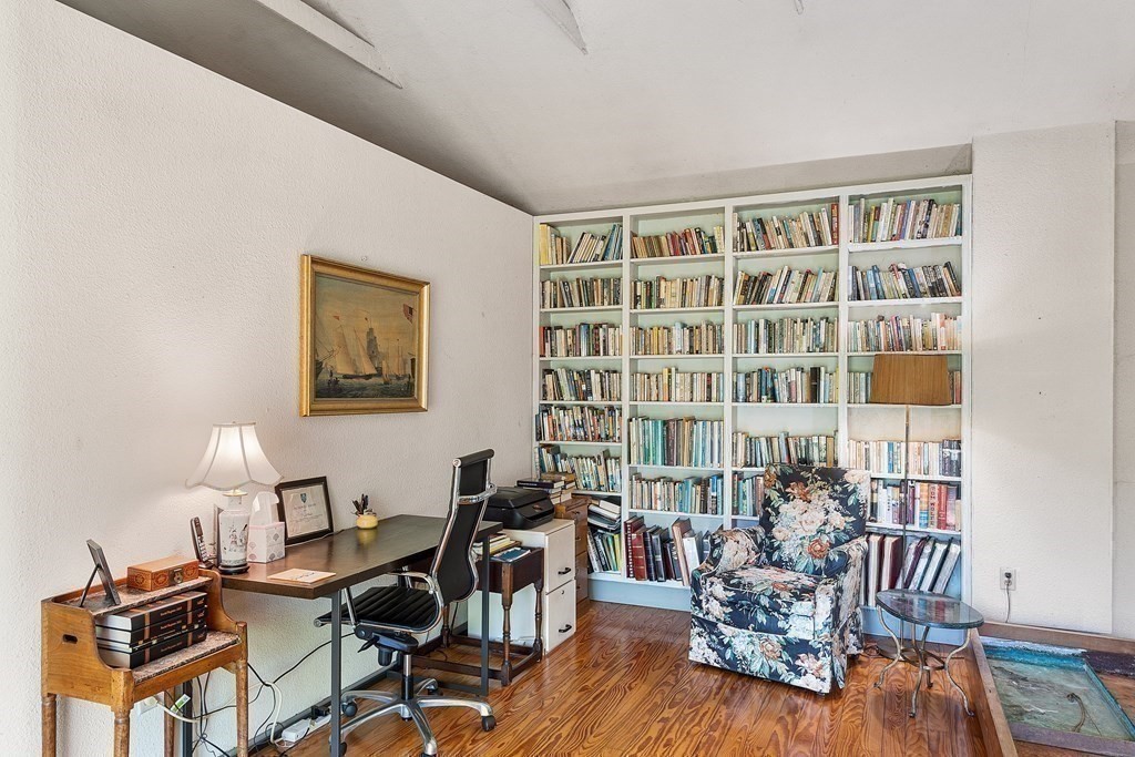 49 Thissell Street Beverly, MA 01915 - Photo 19 of 36 a view of a livingroom with furniture and a book shelf