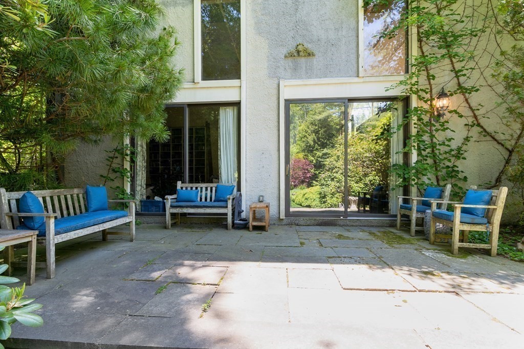 49 Thissell Street Beverly, MA 01915 - Photo 2 of 36 a view of a chair and table in backyard of the house