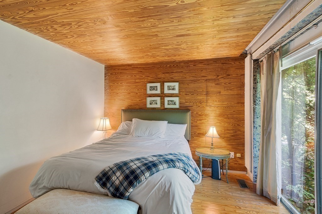 49 Thissell Street Beverly, MA 01915 - Photo 24 of 36 a bed sitting in a bedroom next to a window