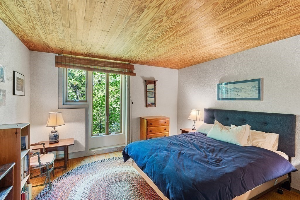 49 Thissell Street Beverly, MA 01915 - Photo 26 of 36 a bedroom with a bed and wooden floor