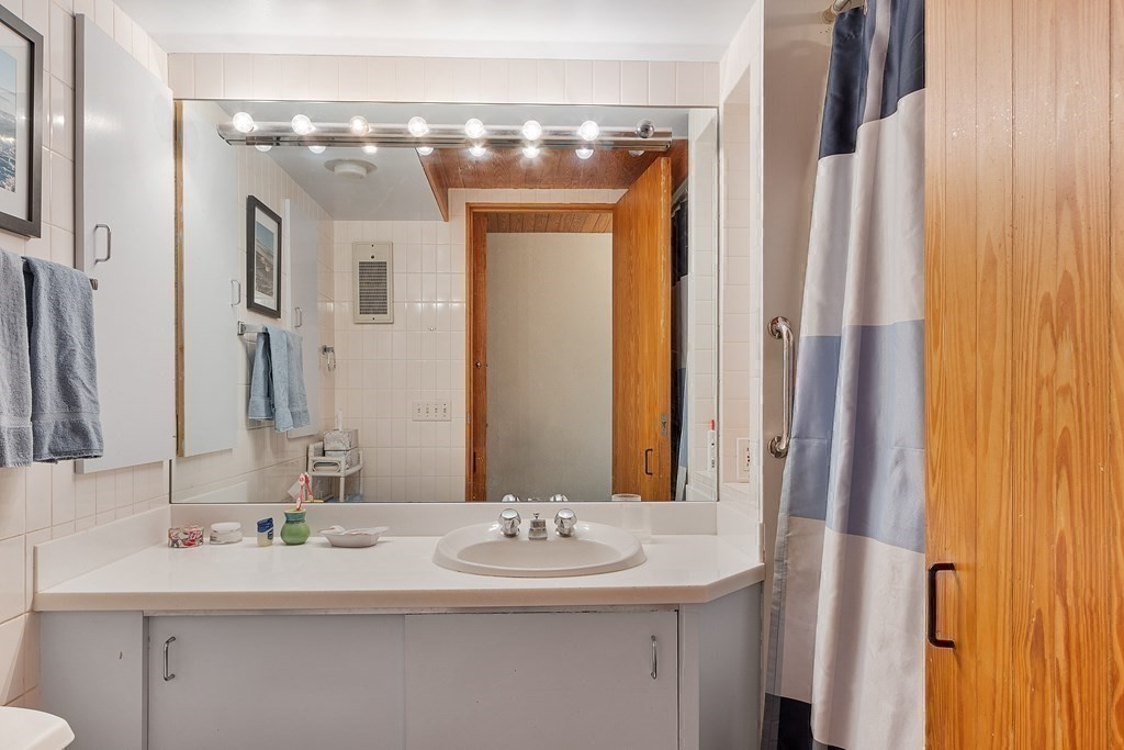 49 Thissell Street Beverly, MA 01915 - Photo 27 of 36 a bathroom with a double vanity sink and a mirror