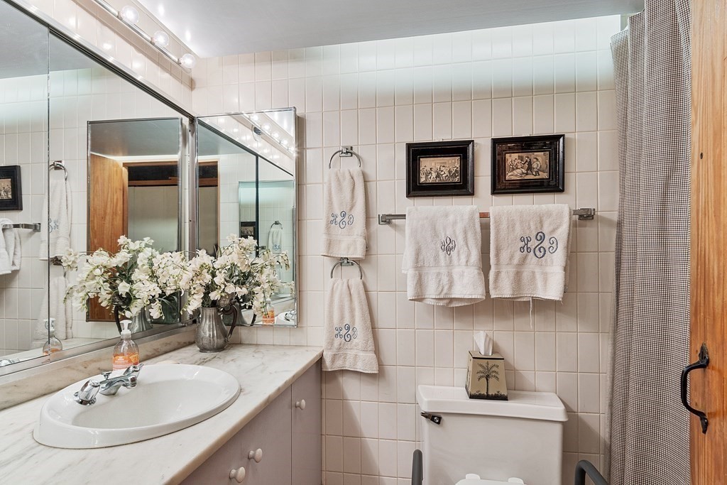 49 Thissell Street Beverly, MA 01915 - Photo 29 of 36 a bathroom with a sink and a mirror