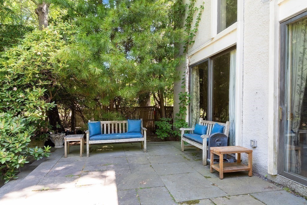 49 Thissell Street Beverly, MA 01915 - Photo 30 of 36 a backyard of a house with a bench and some trees