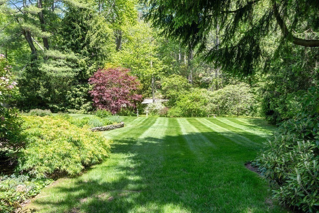 49 Thissell Street Beverly, MA 01915 - Photo 35 of 36 a backyard of a house with lots of green space and garden