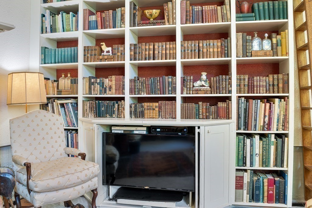 49 Thissell Street Beverly, MA 01915 - Photo 6 of 36 a living room with furniture and a book shelf
