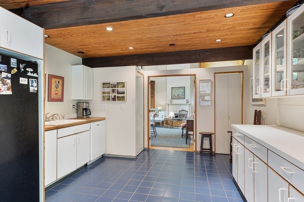 49 Thissell Street Beverly, MA 01915 - Photo 10 of 36 a view of a hallway with a sink and cabinet