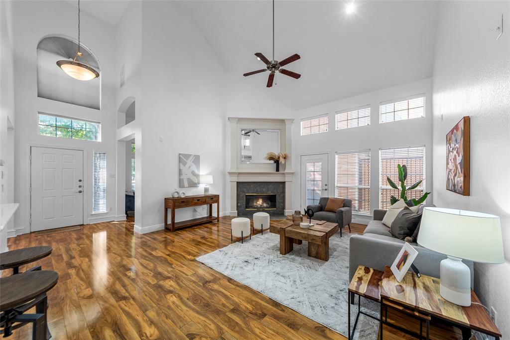 a living room with furniture a fireplace and a chandelier