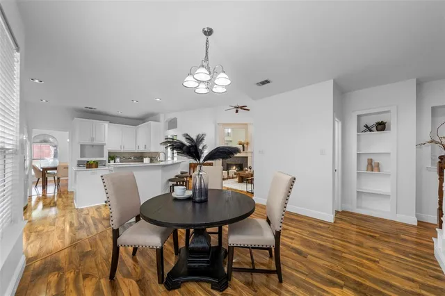 a spacious bedroom with a bed and a chandelier