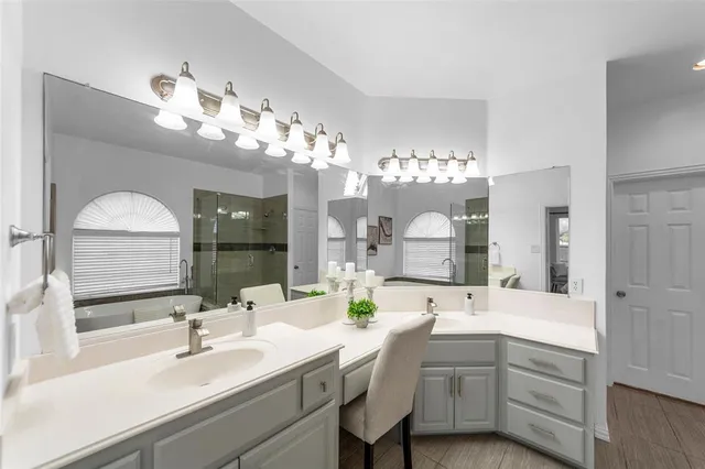 a view of an empty room with a chandelier fan