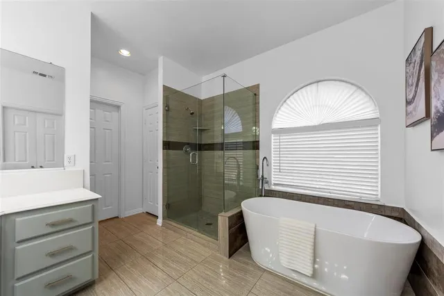 wooden floor in an empty room with a chandelier fan