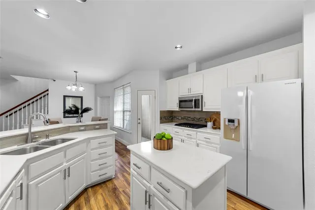 a kitchen with a sink stainless steel appliances and cabinets