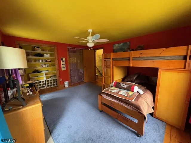 a bedroom with furniture and a lamp