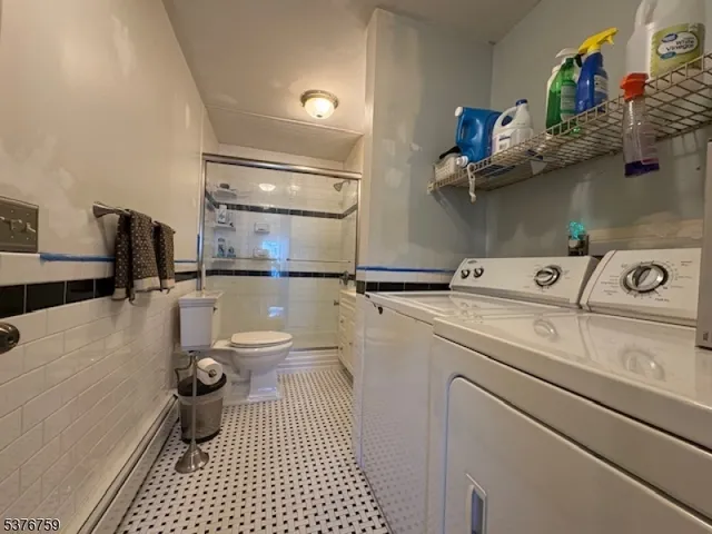 a bathroom with a sink a toilet and a shower