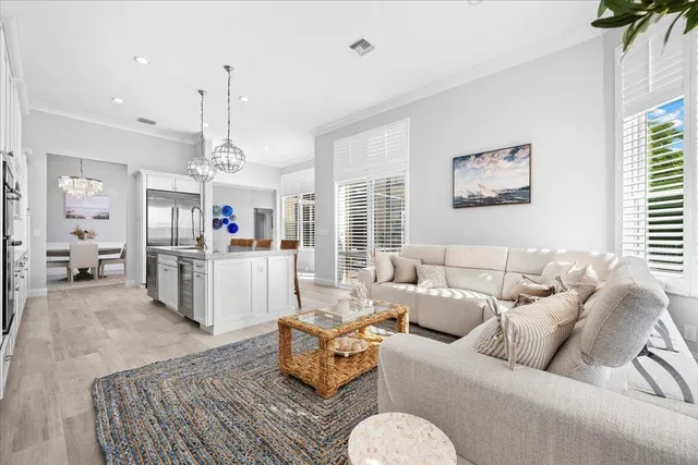 a living room with furniture kitchen and a table