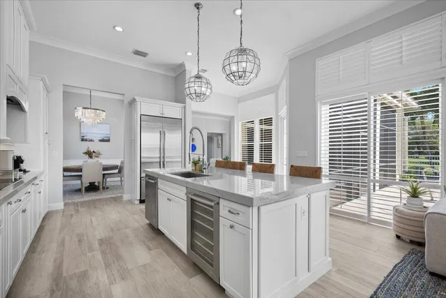 a large kitchen with kitchen island granite countertop a large center island attached withe living room