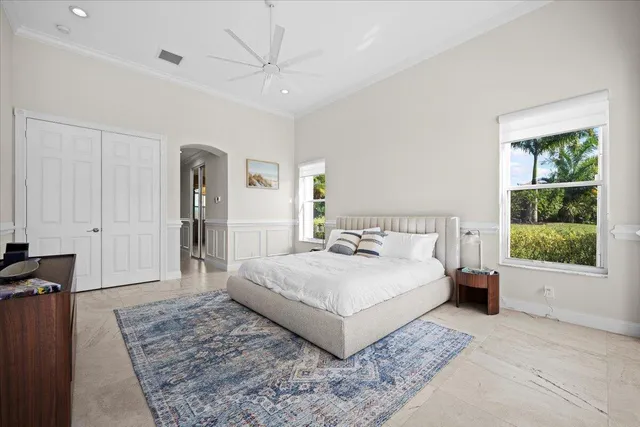 a spacious bedroom with a large bed and a window