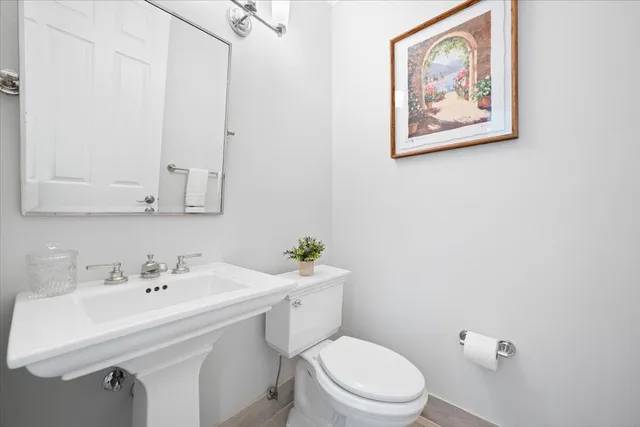 a bathroom with a sink mirror and toilet