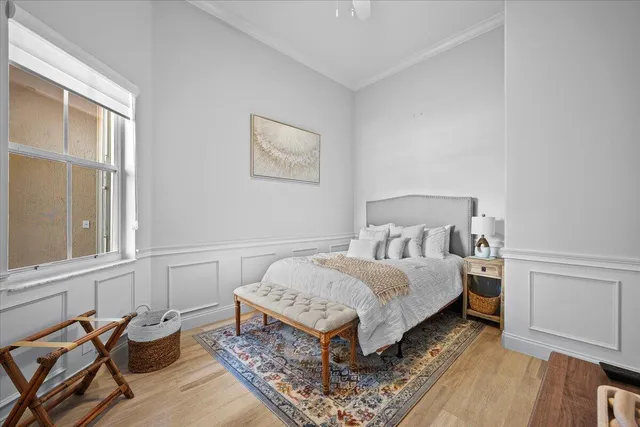 a bedroom with a bed and wooden floor