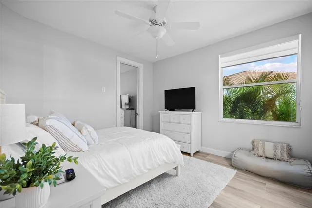 a bedroom with a bed and a television