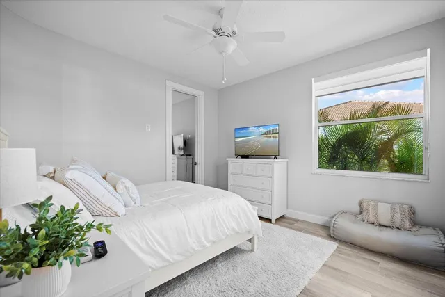 a bedroom with a bed couch and window