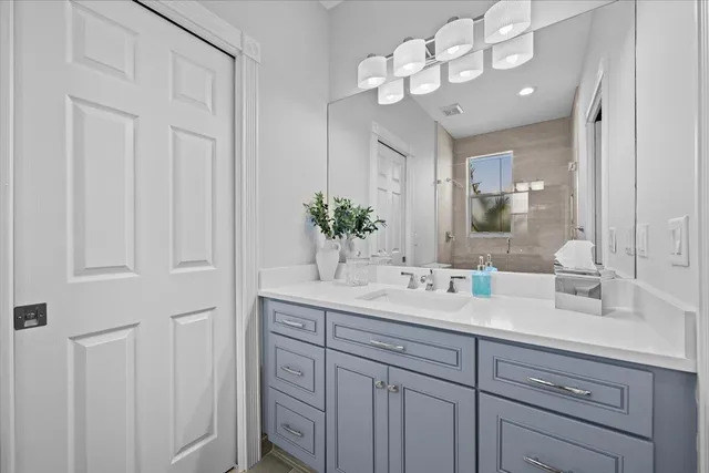 a bathroom with a sink vanity and a mirror