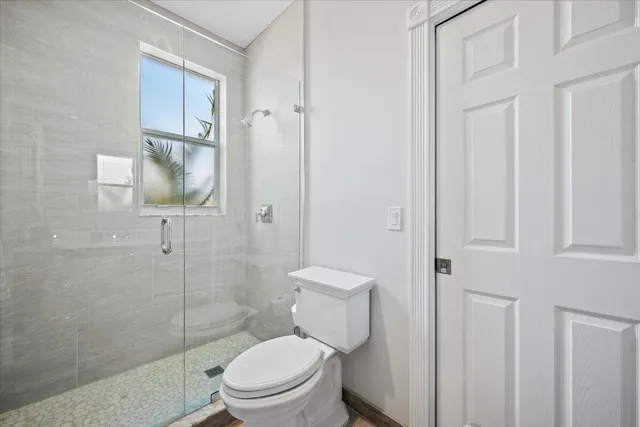 a white toilet sitting next to a bathroom sink