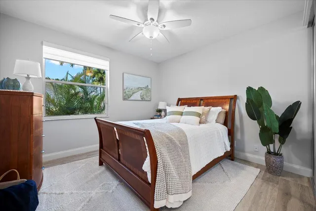 a bed sitting in a spacious bedroom next to a window