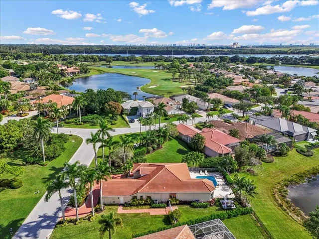 an aerial view of residential houses with outdoor space and lake view