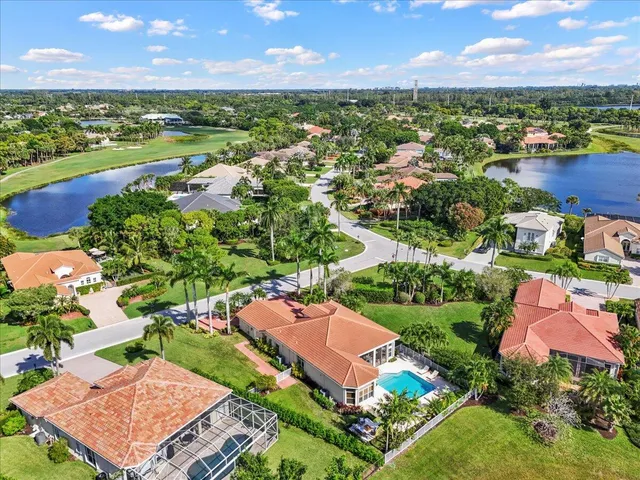 an aerial view of a houses with a lake view