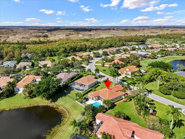 an aerial view of residential houses with outdoor space and trees