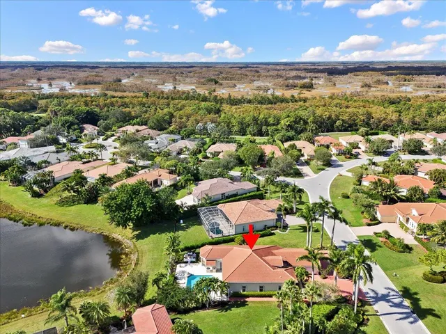 an aerial view of residential houses with outdoor space and trees