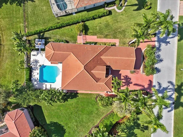 an aerial view of a house with a yard