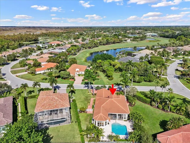 an aerial view of residential houses with outdoor space and ocean view