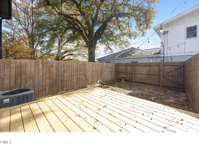 a backyard of a house with a tree